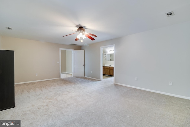 unfurnished living room featuring ceiling fan, light colored carpet, and baseboards