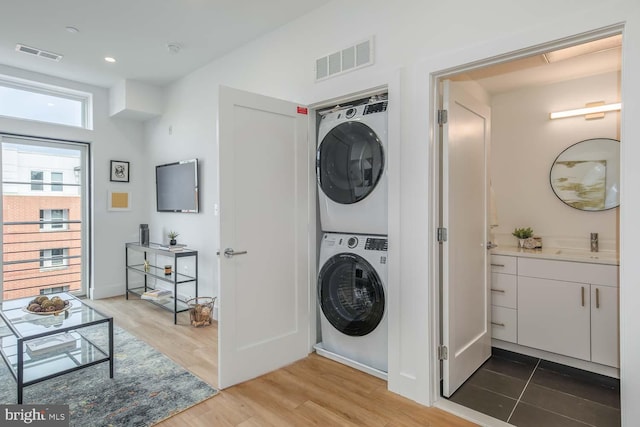 2310 4th St NE Unit 22, Washington, DC 20002 - washroom with stacked washing machine and dryer and wood finished floors