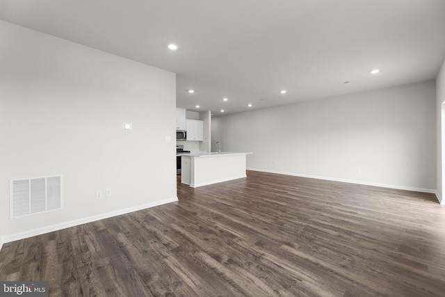 40 Marion Ave, Bordentown, NJ 08505 - unfurnished living room featuring dark wood finished floors, recessed lighting, a sink, and baseboards