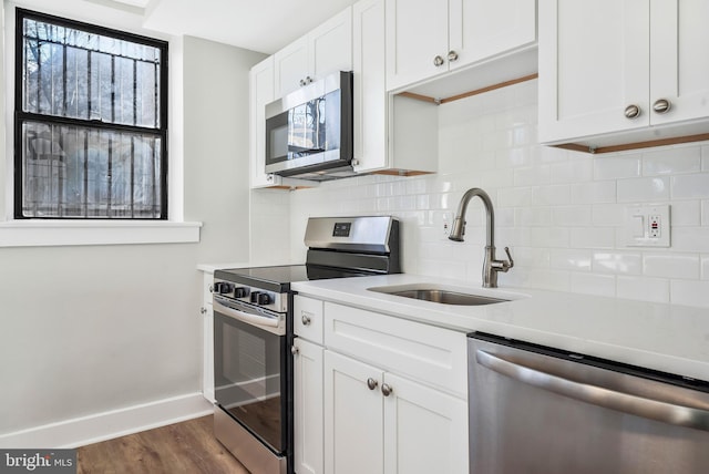 212 Oakwood St SE Unit B5, Washington, DC 20032 - kitchen with stainless steel appliances, baseboards, backsplash, and light countertops