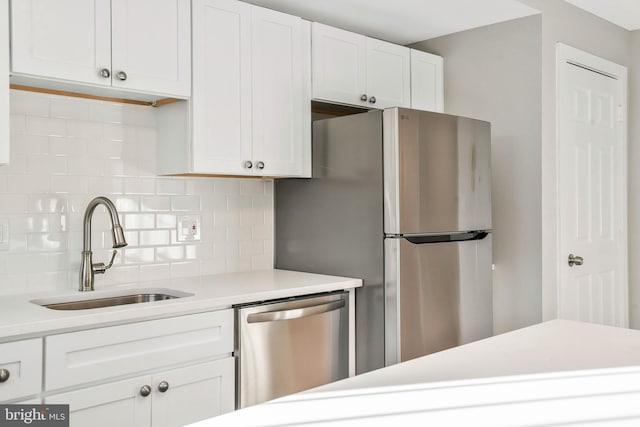 212 Oakwood St SE Unit B5, Washington, DC 20032 - kitchen featuring stainless steel appliances, a sink, decorative backsplash, light countertops, and white cabinets