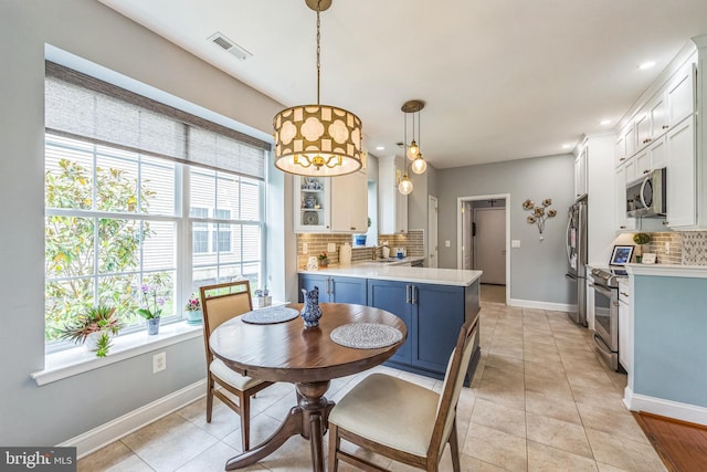 dining area with baseboards, light tile patterned floors, and recessed lighting