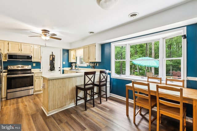 11500 Acton Ln, Waldorf, MD 20601 - kitchen with appliances with stainless steel finishes, dark wood-type flooring, light countertops, and plenty of natural light