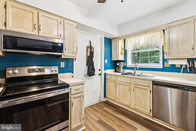 11500 Acton Ln, Waldorf, MD 20601 - kitchen featuring stainless steel appliances, light brown cabinetry, light countertops, and wood finished floors