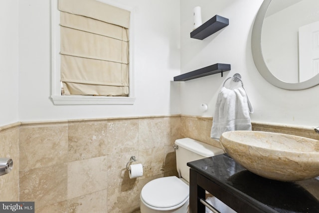 11500 Acton Ln, Waldorf, MD 20601 - half bath featuring tile walls, a wainscoted wall, and vanity