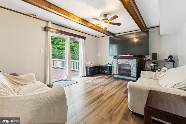 11500 Acton Ln, Waldorf, MD 20601 - living room with wood finished floors, ceiling fan, beamed ceiling, and a fireplace