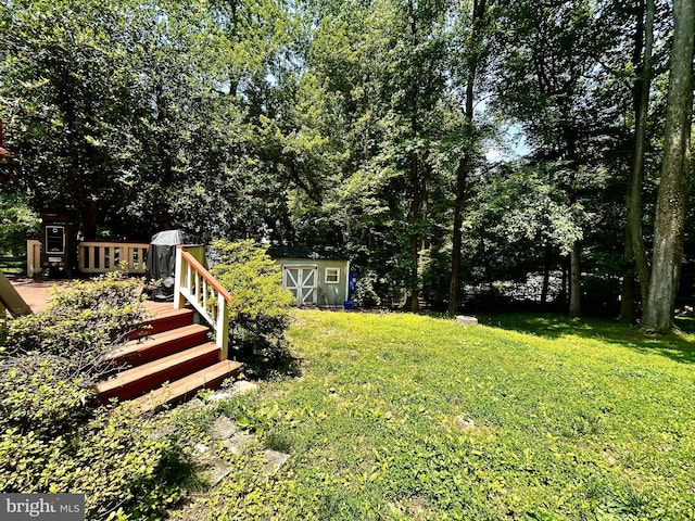11500 Acton Ln, Waldorf, MD 20601 - view of grassy yard with a storage unit and a deck