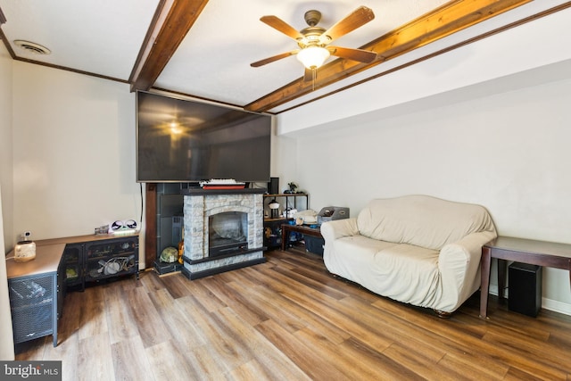 11500 Acton Ln, Waldorf, MD 20601 - living area with wood finished floors, ceiling fan, a fireplace, and beamed ceiling