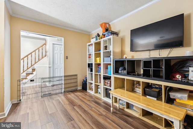 11500 Acton Ln, Waldorf, MD 20601 - sitting room with crown molding, a textured ceiling, wood finished floors, and stairway