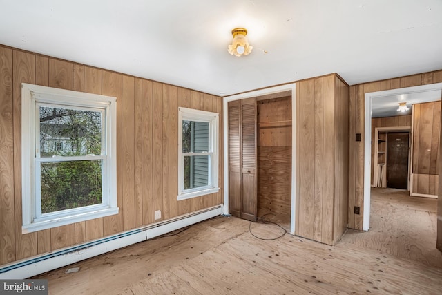 611-615 S New York Rd, Absecon, NJ 08205 - unfurnished bedroom with a baseboard radiator, a closet, and wood walls