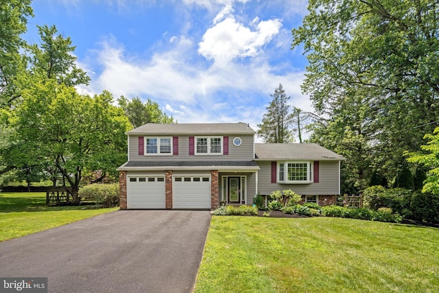 10 Hickory Dr, Doylestown, PA 18901 - split level home featuring driveway, a front yard, brick siding, and an attached garage