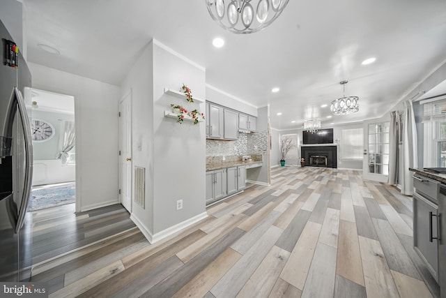 201 Anchor Cv, Stafford, VA 22554 - kitchen featuring a chandelier, gray cabinets, light wood-style floors, recessed lighting, and a fireplace