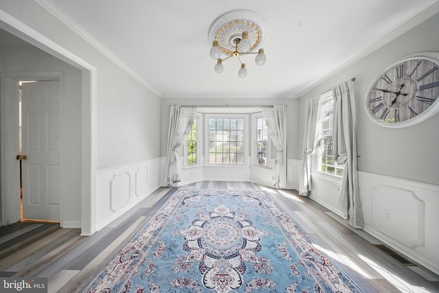 201 Anchor Cv, Stafford, VA 22554 - spare room featuring plenty of natural light, wainscoting, light wood-style floors, ornamental molding, and a decorative wall