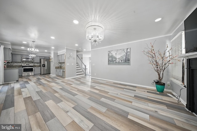 201 Anchor Cv, Stafford, VA 22554 - unfurnished living room featuring a chandelier, recessed lighting, stairway, a sink, and baseboards