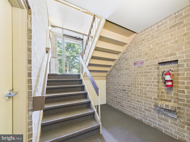 1643 Parkcrest Cir Unit 7C/101, Reston, VA 20190 - stairway featuring brick wall and carpet floors