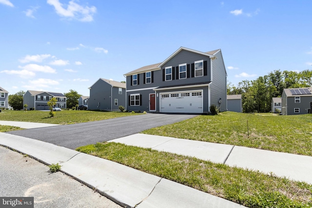 210 Slate Rd, Dover, DE 19904 - view of front of house with a residential view, a garage, asphalt driveway, and a front lawn