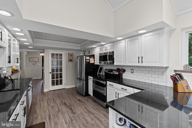 8 Pheasant Run Ct, Lutherville Timonium, MD 21093 - kitchen featuring stainless steel appliances, wood finished floors, white cabinets, tasteful backsplash, and a tray ceiling