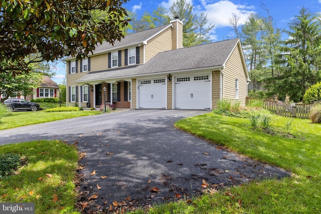 8 Pheasant Run Ct, Lutherville Timonium, MD 21093 - view of front of home with a garage, a chimney, asphalt driveway, roof with shingles, and covered porch
