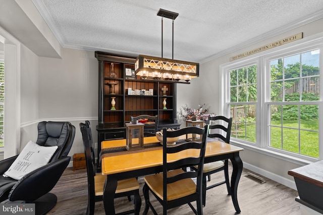 8 Pheasant Run Ct, Lutherville Timonium, MD 21093 - dining space featuring a textured ceiling, ornamental molding, healthy amount of natural light, wood finished floors, and baseboards