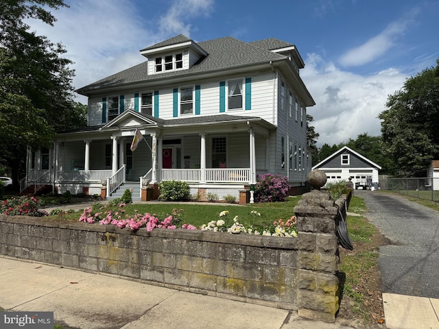 714 W St, Laurel, DE 19956 - view of front of house with a detached garage, covered porch, an outbuilding, and roof with shingles