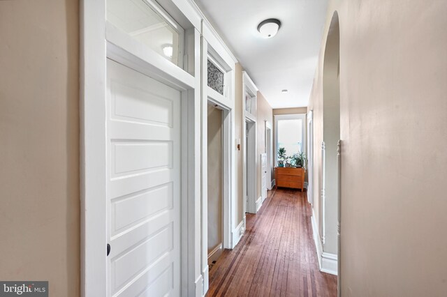 714 W St, Laurel, DE 19956 - hallway with dark wood finished floors, arched walkways, and baseboards