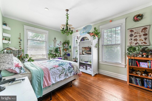 714 W St, Laurel, DE 19956 - bedroom featuring a chandelier, ornamental molding, multiple windows, wood finished floors, and baseboards