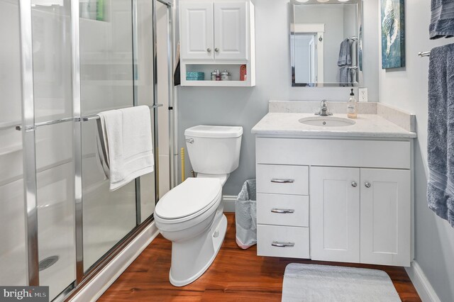 714 W St, Laurel, DE 19956 - full bathroom with vanity, wood finished floors, a stall shower, and toilet