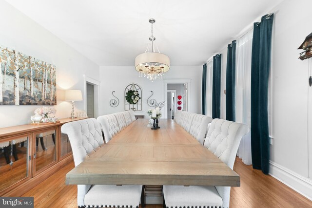714 W St, Laurel, DE 19956 - dining room with a chandelier, light wood-style flooring, and baseboards