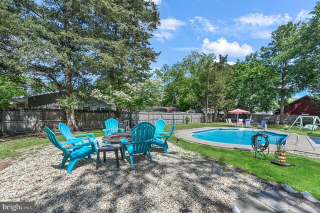714 W St, Laurel, DE 19956 - view of swimming pool featuring an outdoor fire pit, a fenced backyard, and a patio