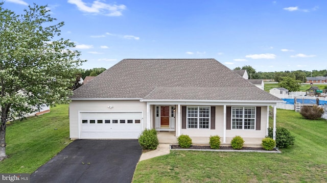 view of front of property featuring asphalt driveway, a garage, a front yard, and roof with shingles