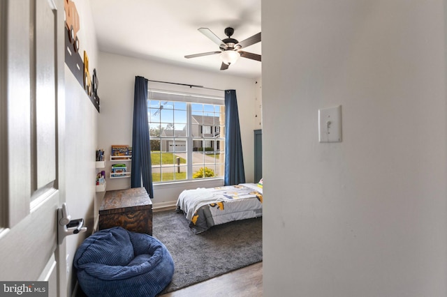 bedroom with wood finished floors, ceiling fan, and baseboards