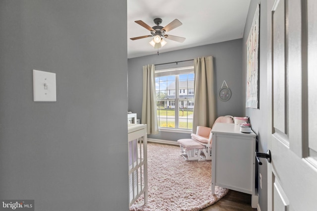 bedroom with wood finished floors, baseboards, and a ceiling fan