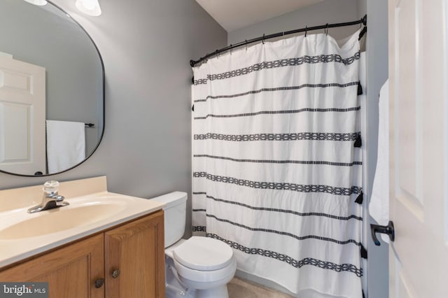 bathroom with toilet, vanity, and a shower with curtain