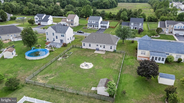 aerial perspective of suburban area featuring a pool