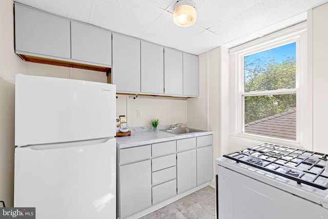 46 Murray Ave, Annapolis, MD 21401 - kitchen featuring white appliances, a sink, light countertops, and a drop ceiling