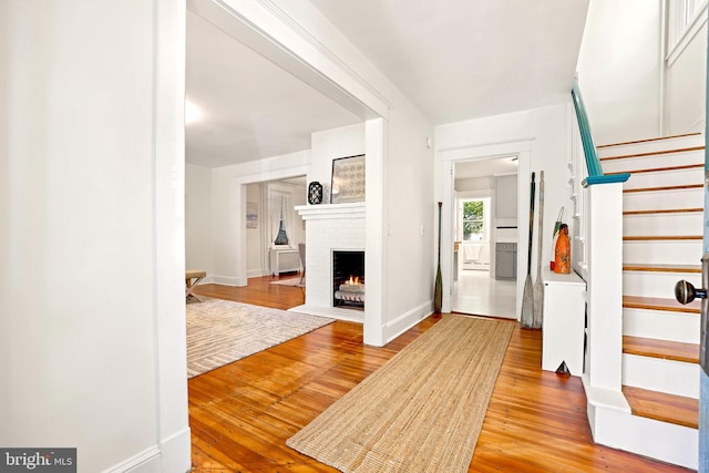46 Murray Ave, Annapolis, MD 21401 - entrance foyer featuring stairs, hardwood / wood-style flooring, a fireplace, and baseboards