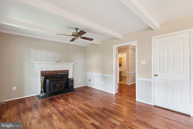 10007 Marshall Pond Rd, Burke, VA 22015 - unfurnished living room featuring beamed ceiling, a ceiling fan, a wood stove, and wood finished floors