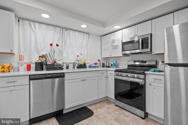 2020 Valley View Dr, Folcroft, PA 19032 - kitchen with stainless steel appliances, recessed lighting, light countertops, white cabinets, and a sink
