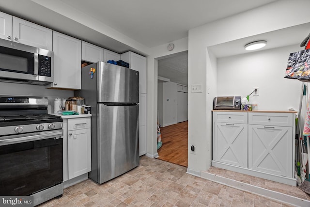 2020 Valley View Dr, Folcroft, PA 19032 - kitchen featuring appliances with stainless steel finishes, stone finish flooring, and white cabinetry