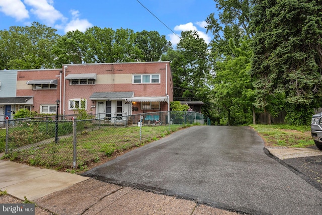 2020 Valley View Dr, Folcroft, PA 19032 - townhome / multi-family property with a fenced front yard, brick siding, and asphalt driveway