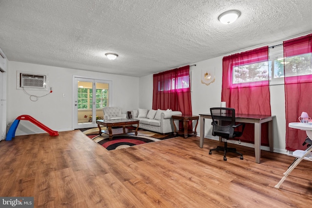 2020 Valley View Dr, Folcroft, PA 19032 - living room with a textured ceiling, wood finished floors, a wall mounted AC, and baseboards