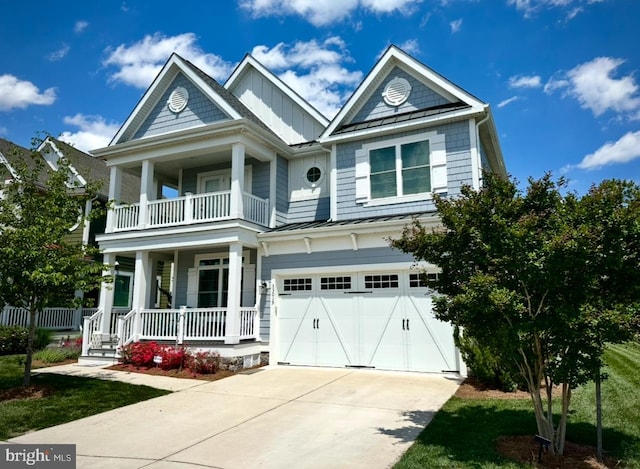 33015 Shadeland Ave, Millsboro, DE 19966 - view of front of home with a porch, a balcony, a standing seam roof, concrete driveway, and a garage