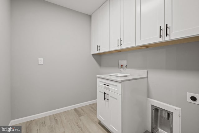 1500A Embassy, Harrisburg, PA 17109 - laundry room featuring hookup for an electric dryer, cabinet space, light wood-style floors, hookup for a washing machine, and baseboards