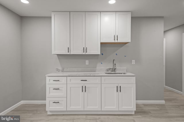 1500A Embassy, Harrisburg, PA 17109 - kitchen with a sink, baseboards, white cabinetry, light countertops, and recessed lighting