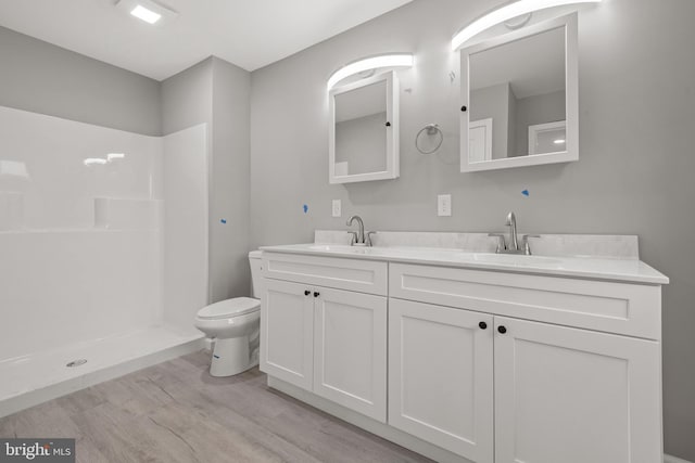 1500A Embassy, Harrisburg, PA 17109 - full bath featuring wood finished floors, double vanity, toilet, and a shower