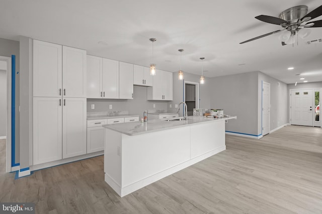 1500A Embassy, Harrisburg, PA 17109 - kitchen featuring a sink, baseboards, white cabinetry, and recessed lighting