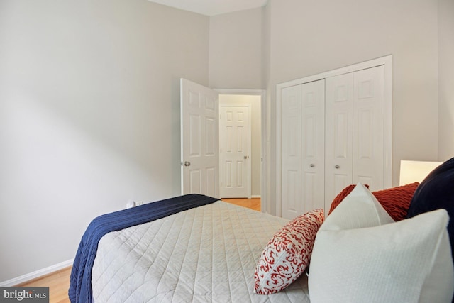 14321 Long Channel Dr, Germantown, MD 20874 - bedroom featuring a closet, light wood-type flooring, and a high ceiling