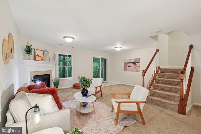 14321 Long Channel Dr, Germantown, MD 20874 - living room featuring carpet floors, a glass covered fireplace, and stairs