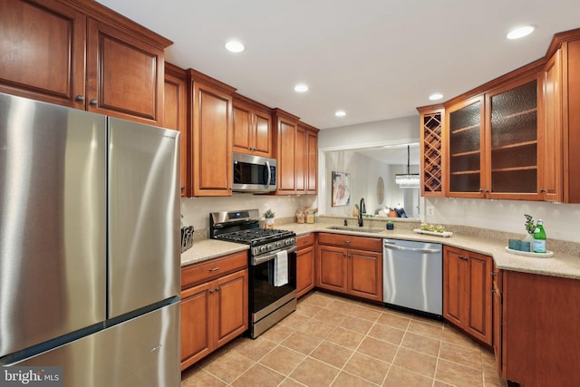 14321 Long Channel Dr, Germantown, MD 20874 - kitchen with appliances with stainless steel finishes, glass insert cabinets, light tile patterned floors, recessed lighting, and brown cabinetry
