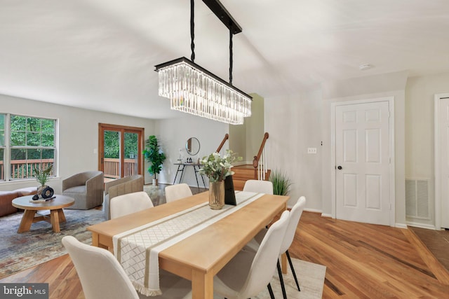 14321 Long Channel Dr, Germantown, MD 20874 - dining room with a chandelier, wood finished floors, and stairs